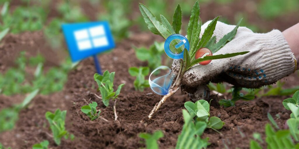 Gloved hand pulling weed with unnecessary software icons from a garden