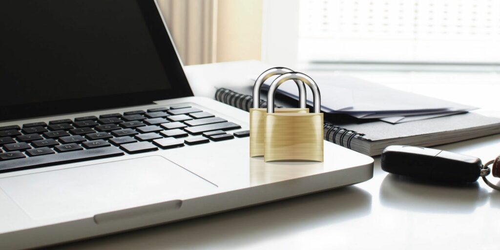 MacBook with two padlocks on it.