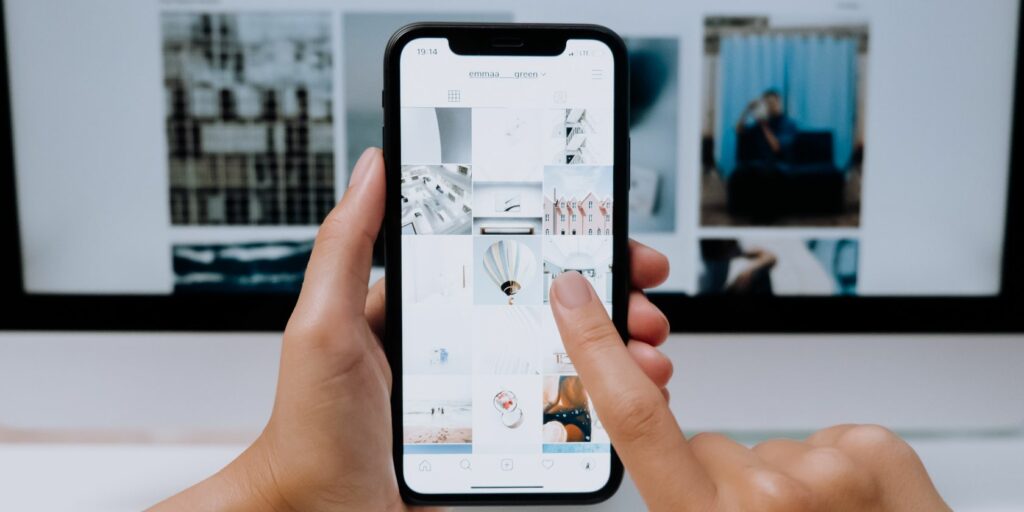 Photo of a person hovering over Instagram on his phone