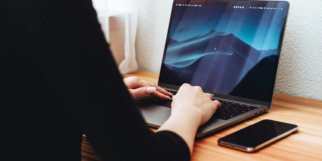 Person using MacBook on a desk