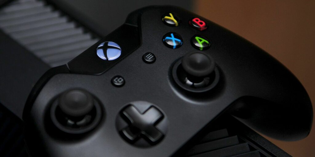 Xbox One controller on top of Xbox console