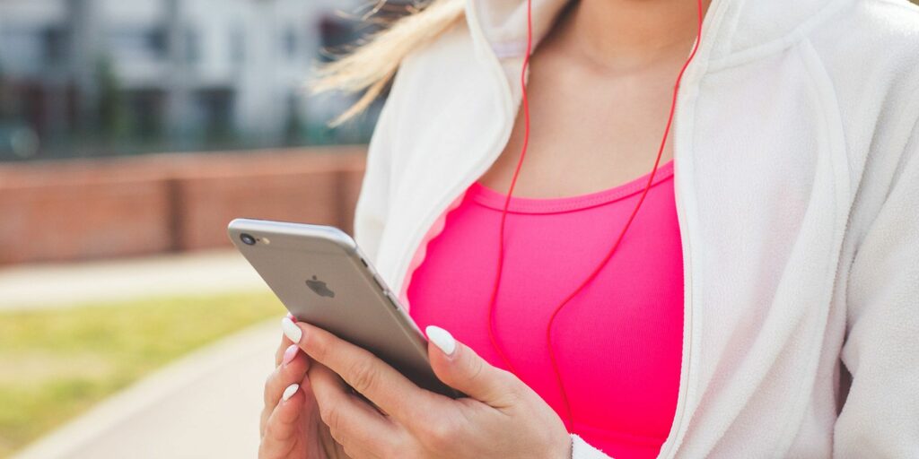 Woman listening to iPhone with earphones