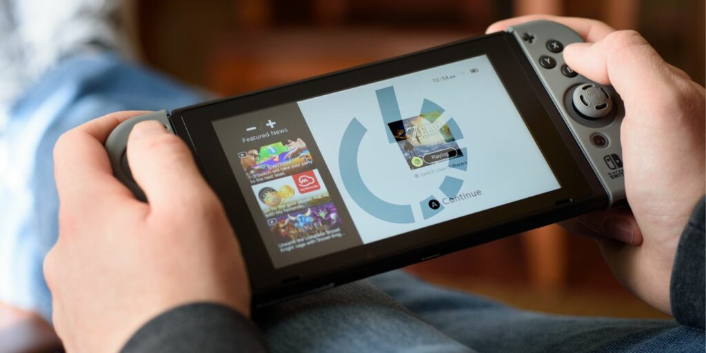 Nintendo switch in hands with power icon on it