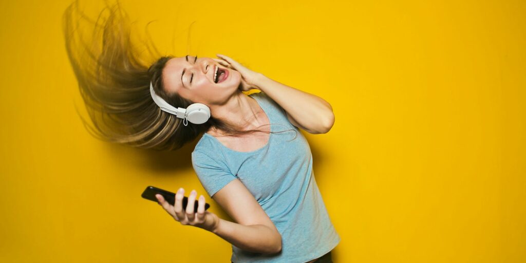lady rocking out to music while wearing headphones