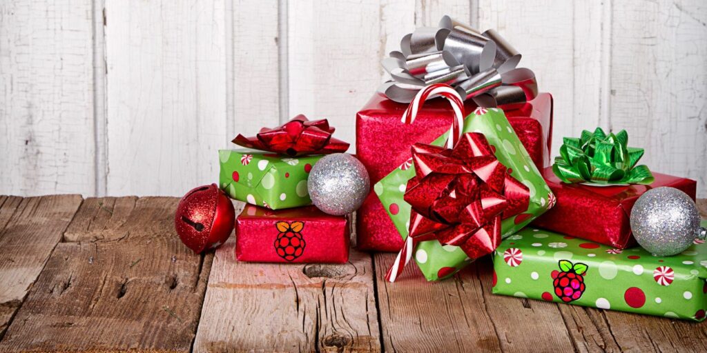 christmas-presents-and-ornaments-on-wooden-background