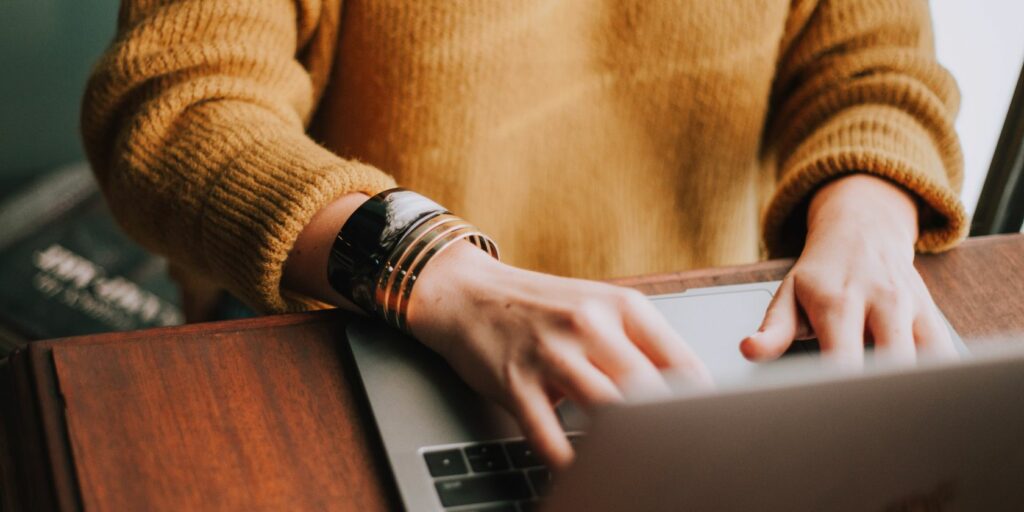 Photo of a person working on their laptop