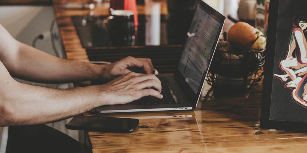 Person using Mac on a table