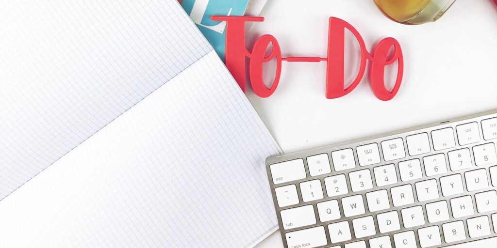 To-do sign placed next to a keyboard and notebook