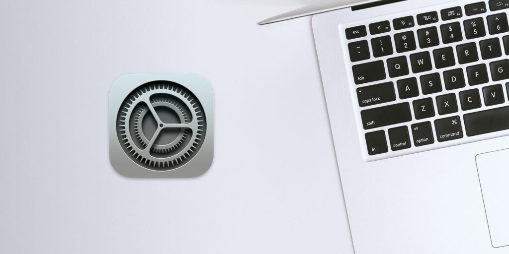 Mac on table with System Preferences logo