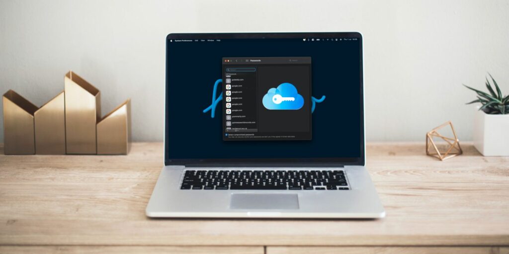 MacBook sat on a desk with a screenshot of the iCloud Keychain page on Mac.