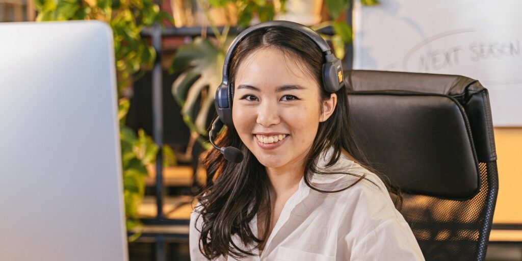 Smiling woman wearing a headset in an office